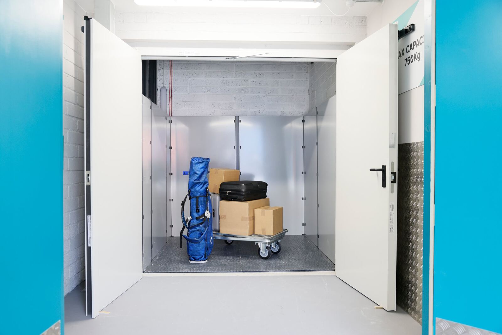Stow goods lift Goods lift at Stow Self Storage with a trolley of boxes, suitcases and a golf bag
